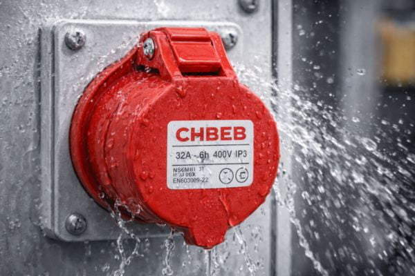 An IP44-rated industrial socket being splashed with water