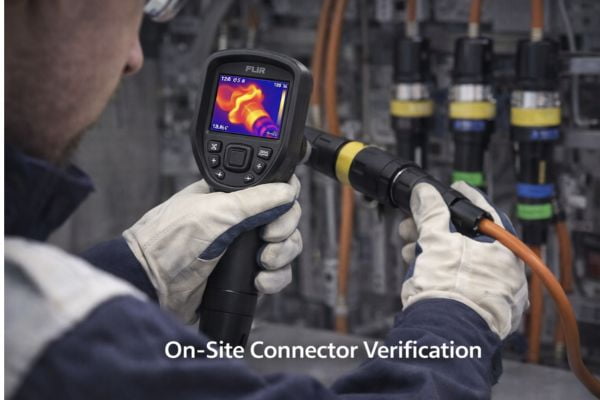 An engineer testing a connector with a thermal camera